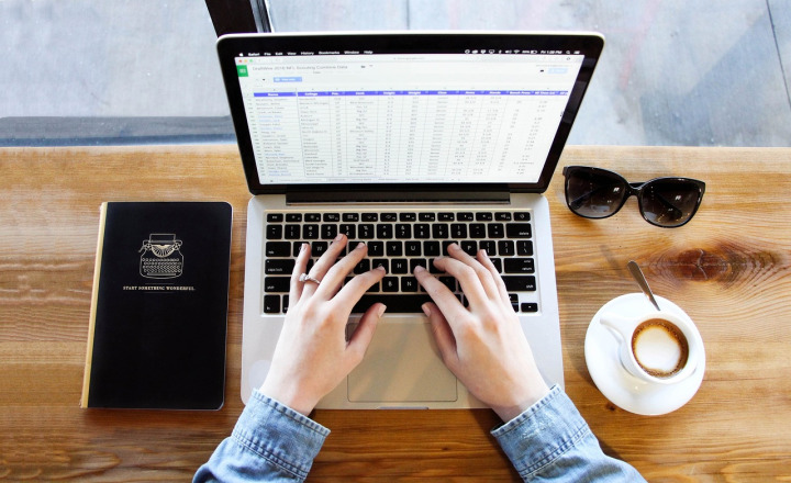journalist typing keyboard desk